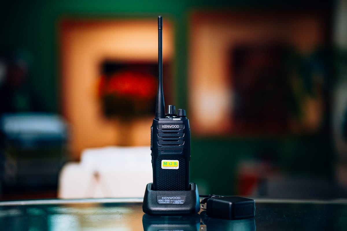 Kenwood two-way radio sitting in its charger